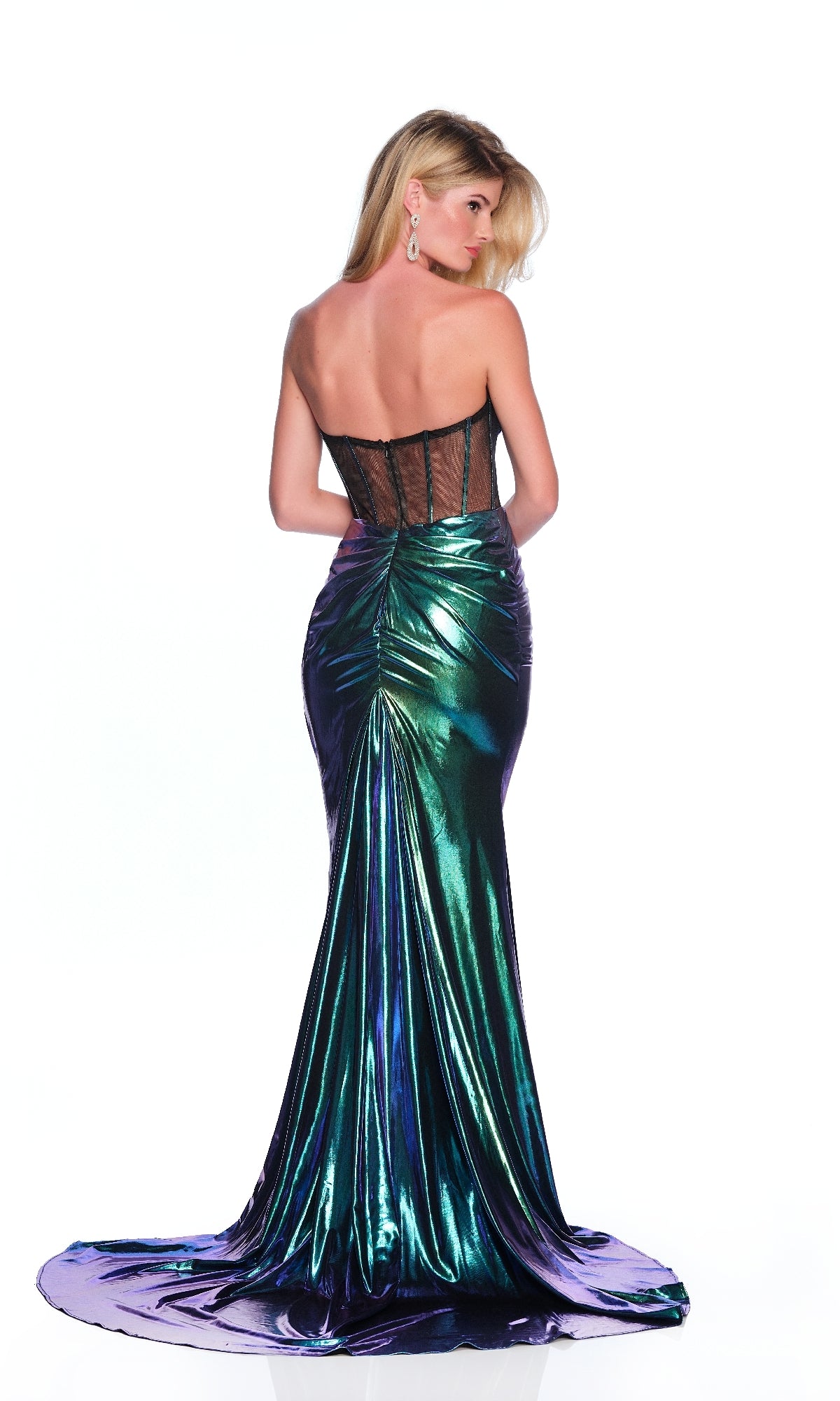 A woman faces away, modeling the Dave & Johnny 12286 long prom dress—a strapless metallic green gown with a sheer black corset back and ruched details—set against a plain white background.